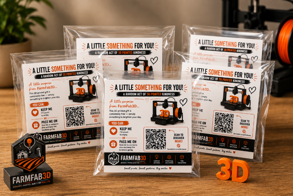 Several clear plastic bags containing printed FarmFab3D gift cards are arranged on a wooden tabletop, with a branded black-and-orange box and orange 3D lettering in the foreground.